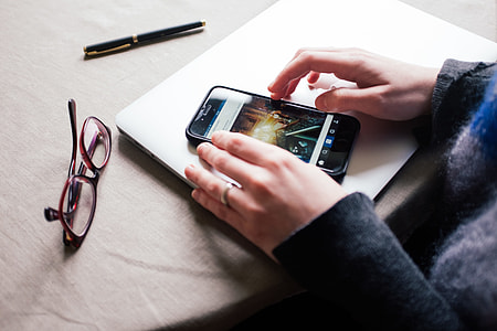 Girl is using Instagram on her iPhone thumbnail
