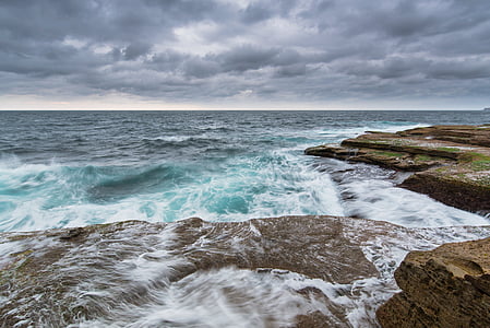 waves smashing through rocks thumbnail