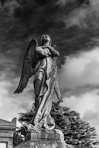 gray angel statue under cloudy sky thumbnail