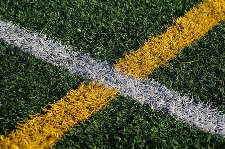 grass field with yellow and white paint thumbnail