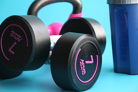 selective focus photography of black and pink Apus Sports fixed-weight dumbbells thumbnail