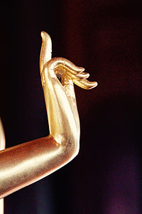 brass-colored hand figurine thumbnail