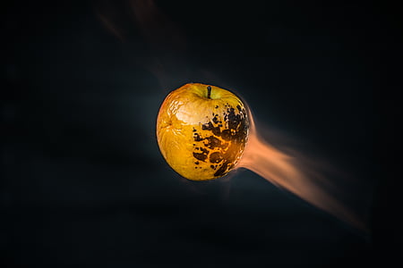 yellow apple against black background thumbnail