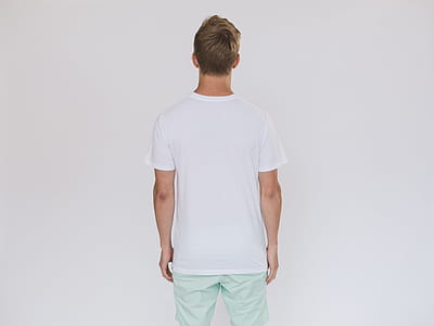 man standing in front of white wall thumbnail