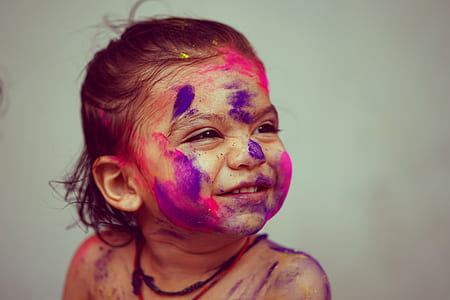 closeup photo of girl smiling with paint on her face thumbnail