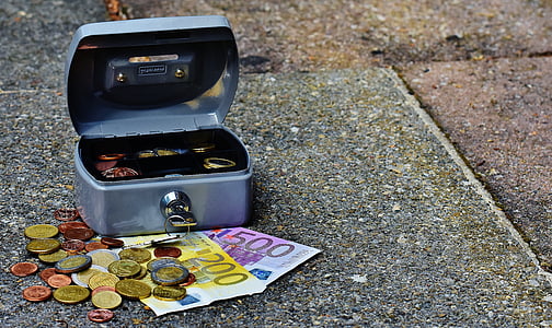 coins and banknotes on gray concrete surface thumbnail