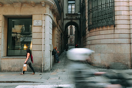 Woman in Black Walking Near Glass Window thumbnail