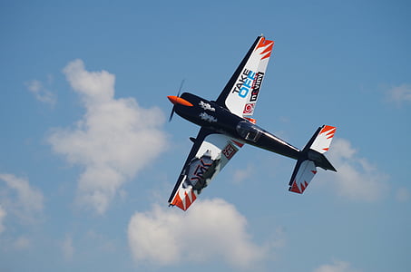 blue and white airplane mid air thumbnail