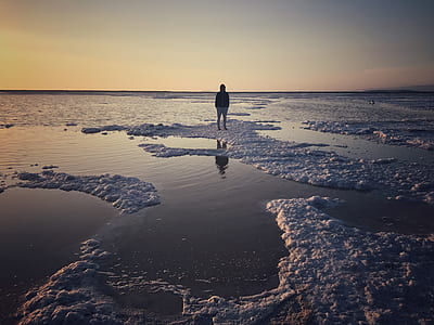 man standing on melted ice cap thumbnail