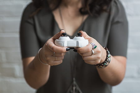 person holding white game controller thumbnail