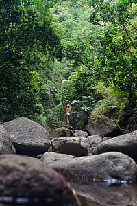 woman standing on rocks thumbnail