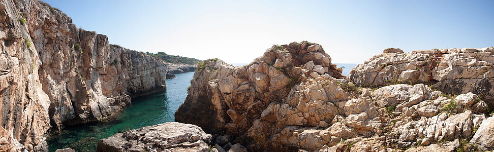rock formations near body of water thumbnail