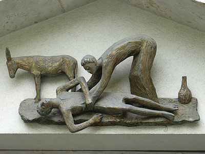 person lifting unconscious person on ground beside donkey figurine thumbnail