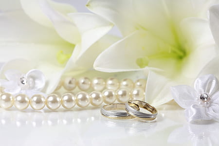 silver-colored rings and white pearl necklace thumbnail