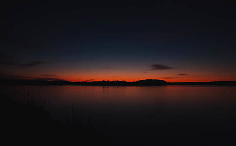 silhouette of calm body of water thumbnail