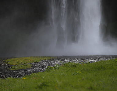 low-angle view photo of waterfall near grass field thumbnail