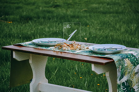 two white plates on table runner on table thumbnail
