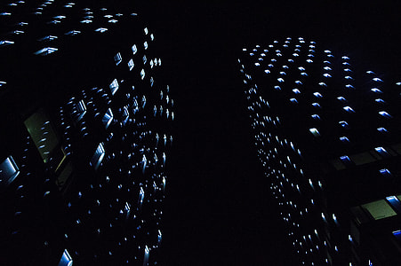 worm's eye view of city buildings during night thumbnail