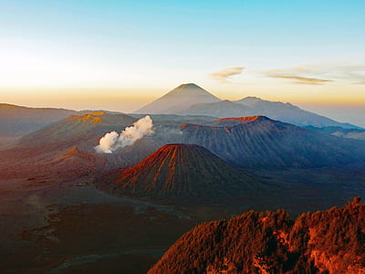 aerial photography of mountain under blue sky thumbnail