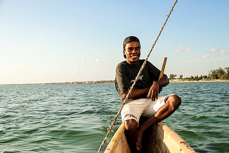 man smiling while sailing on boat thumbnail