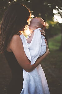 photo of woman carrying baby thumbnail
