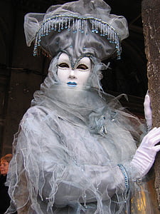 white and gray jester clown standing near brown painted wall thumbnail