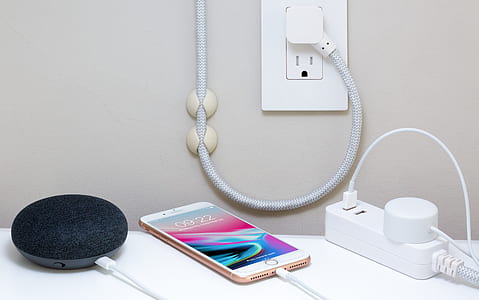 gold iPhone 6 on side of white power strip thumbnail