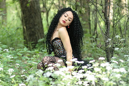 woman wearing black tube dress sitting on the flowers thumbnail