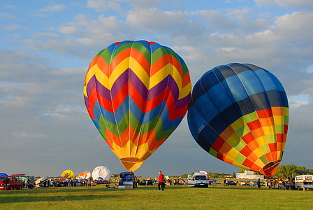 two assorted-color hot air balloons on field thumbnail