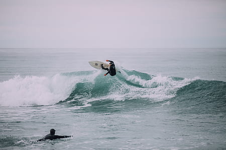 man in black rashguard surfing on wave thumbnail