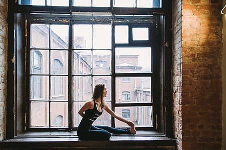 Woman Stretching Beside Window thumbnail