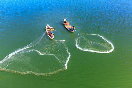 two person fishing on body of water at daytime thumbnail