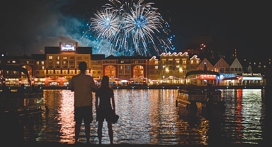 man and woman standing in front of body of water thumbnail