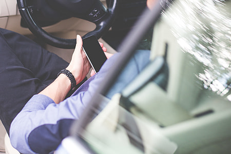 Business Manager Using His Phone in a Car thumbnail