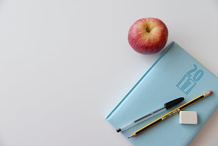 apple beside teal book and pencil thumbnail