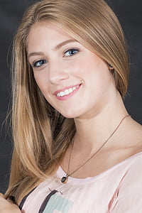 smiling woman in pink scoop-neck shirt thumbnail