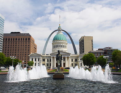 photography of human statue on fountain during daytime thumbnail