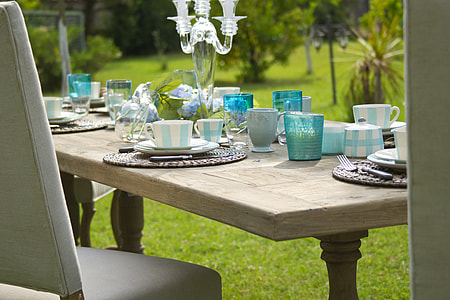 rectangular brown wooden dining table full of white-and-blue dinnerware set thumbnail