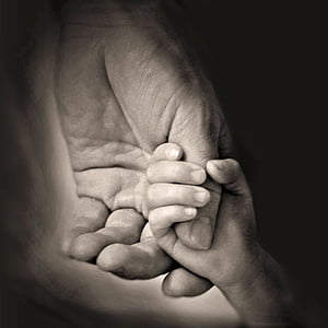 child and person holding hands thumbnail
