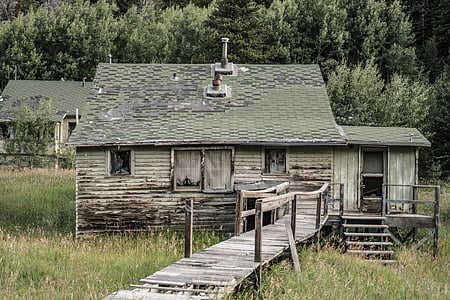 old wooden house near trees thumbnail