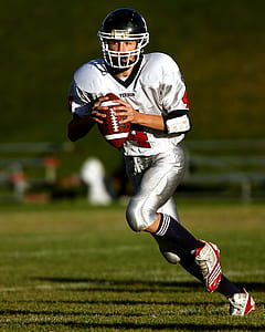 Man Holding Football While Running thumbnail
