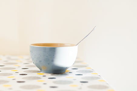 silver spoon in white bowl on table thumbnail
