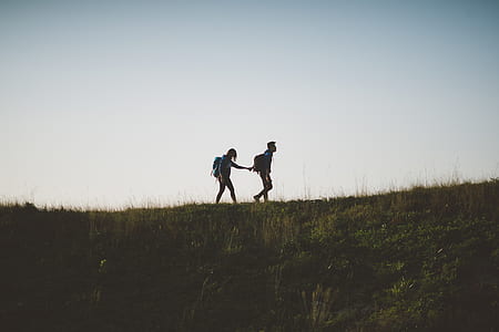 two person walking on top of hill thumbnail