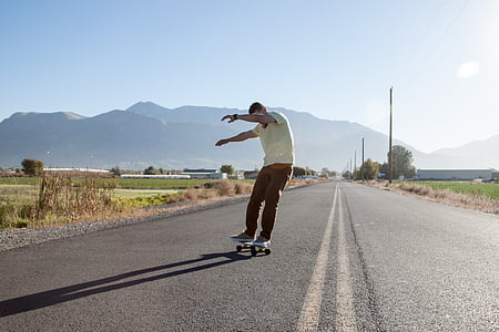 man skateboarding on the road thumbnail