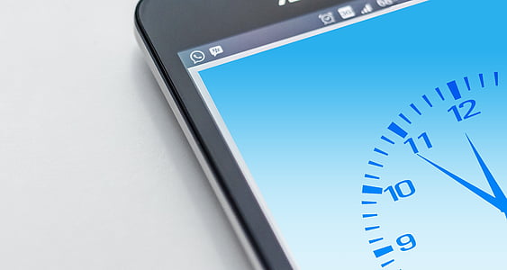 gray Android smartphone showing analog clock thumbnail