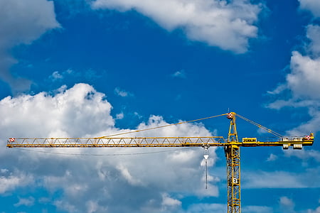 yellow building crane during daytime thumbnail