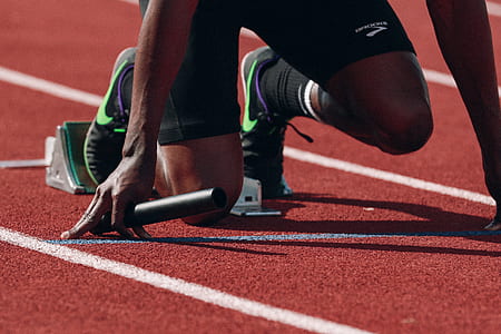 man wearing pair of black-and-green Nike shoes thumbnail