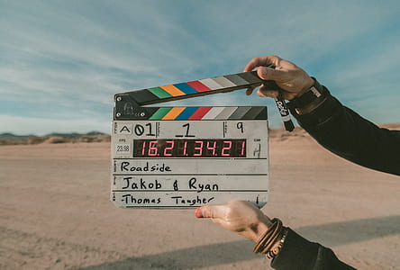 person holding a white and black clapper thumbnail