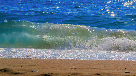 black sand on seashore with ocean wave thumbnail