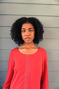 woman leaning on blue wall thumbnail